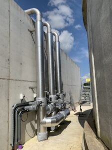 Pipework insulated with fiberglass rockwool sections and clad with aluminium in a waste water treatment facility in Donegal