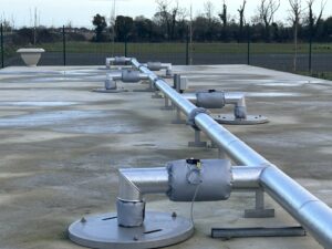 Pipework insulated with fiberglass rockwool sections and clad with aluminium in a waste water treatment facility in Donegal