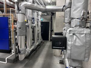 Insulated pipework and mechanical equipment in an industrial plant room