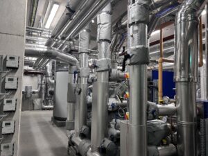 Insulated pipework and mechanical equipment in an industrial plant room