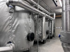 Three large heating buffer vessels in a plantroom insulated with high efficiency thermal covers supplied by Lagforce in Dublin