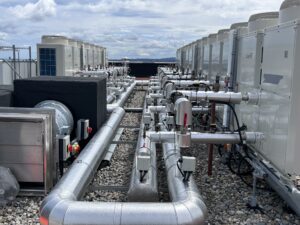 Industrial pipework system insulated with fiberglass and clad with aluminium on a large LTHW heating system in Dublin