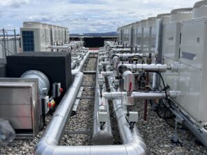External insulated pipework beside roof plant