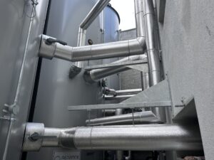 Aluminium cladding installed on external pipework in a new distillery
